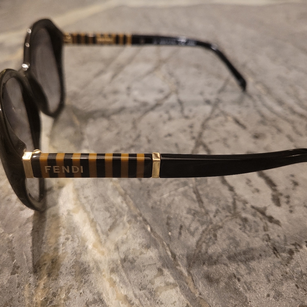 Black gradient FENDI sunglasses with tan stripes on arms